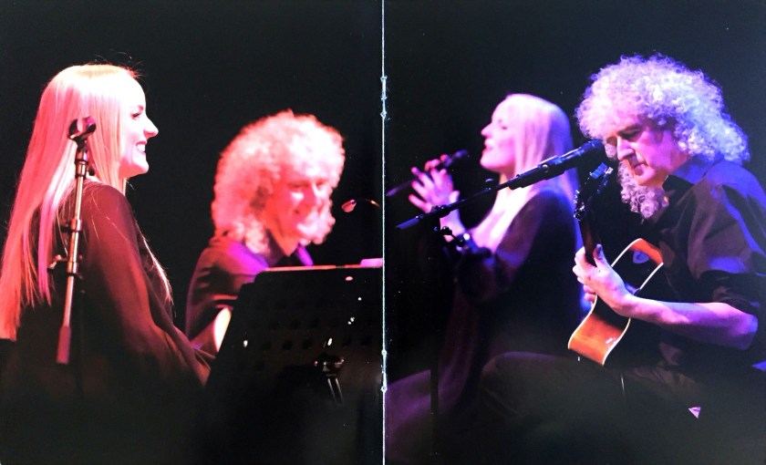 Centre pages of the Blu-ray booklet for The Candlelight Concerts, showing Kerry Ellis and Brian May sitting on stools as they perform on stage. The left photo shows them smiling widely, while the right photo shows them concentrating as they perform.
