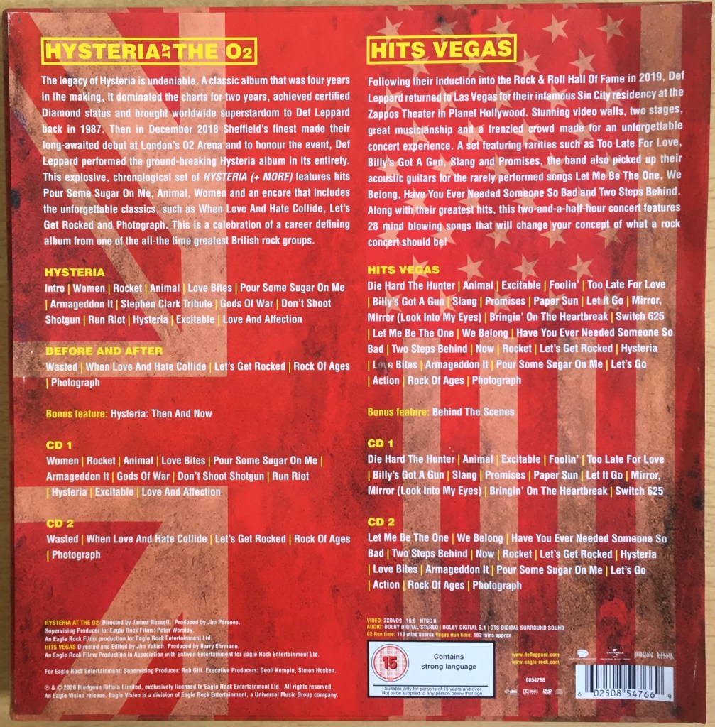 Back of the box for the Def Leppard London To Vegas box set, showing descriptions and track listings for the DVDs and CDs. The UK and USA flags are faded into the red background, so that the text on top stands out more easily, with the headings in yellow and text in white.