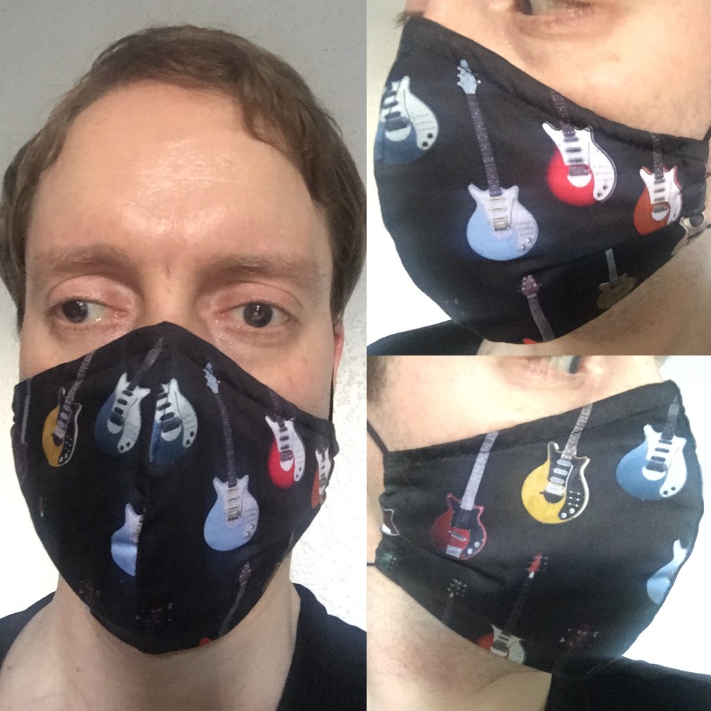 Glen wearing a black face mask decorated with electric guitars.