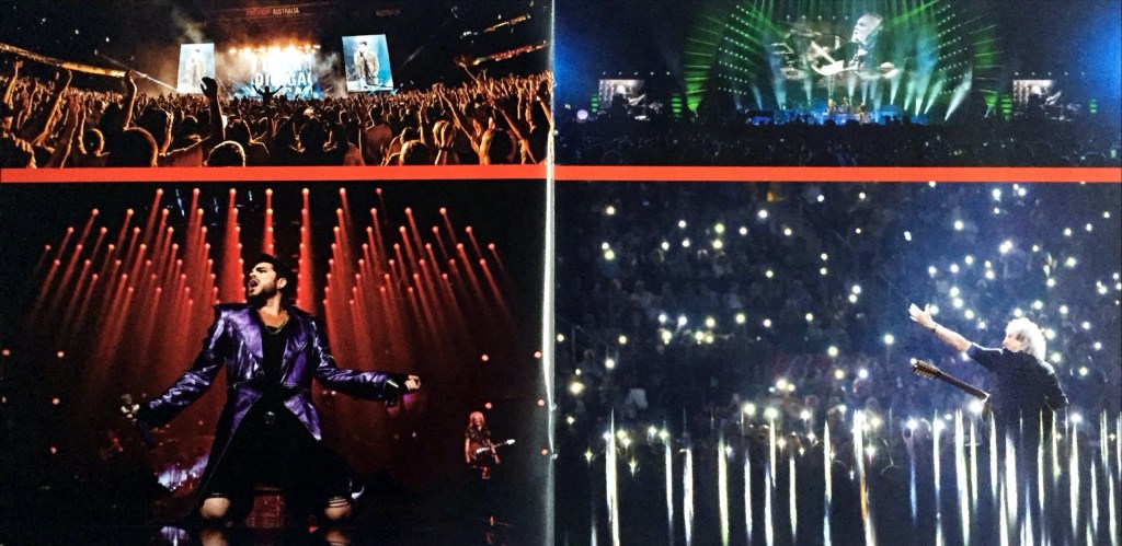 2-page spread from the Live Around The World album booklet by Queen and Adam Lambert. The left page shows Adam striking a star-like pose with arms out to the sides and legs apart as he sings. The right page shows Brian gesturing to the crowd as he sits among a beautiful universe of torchlights from their phones.