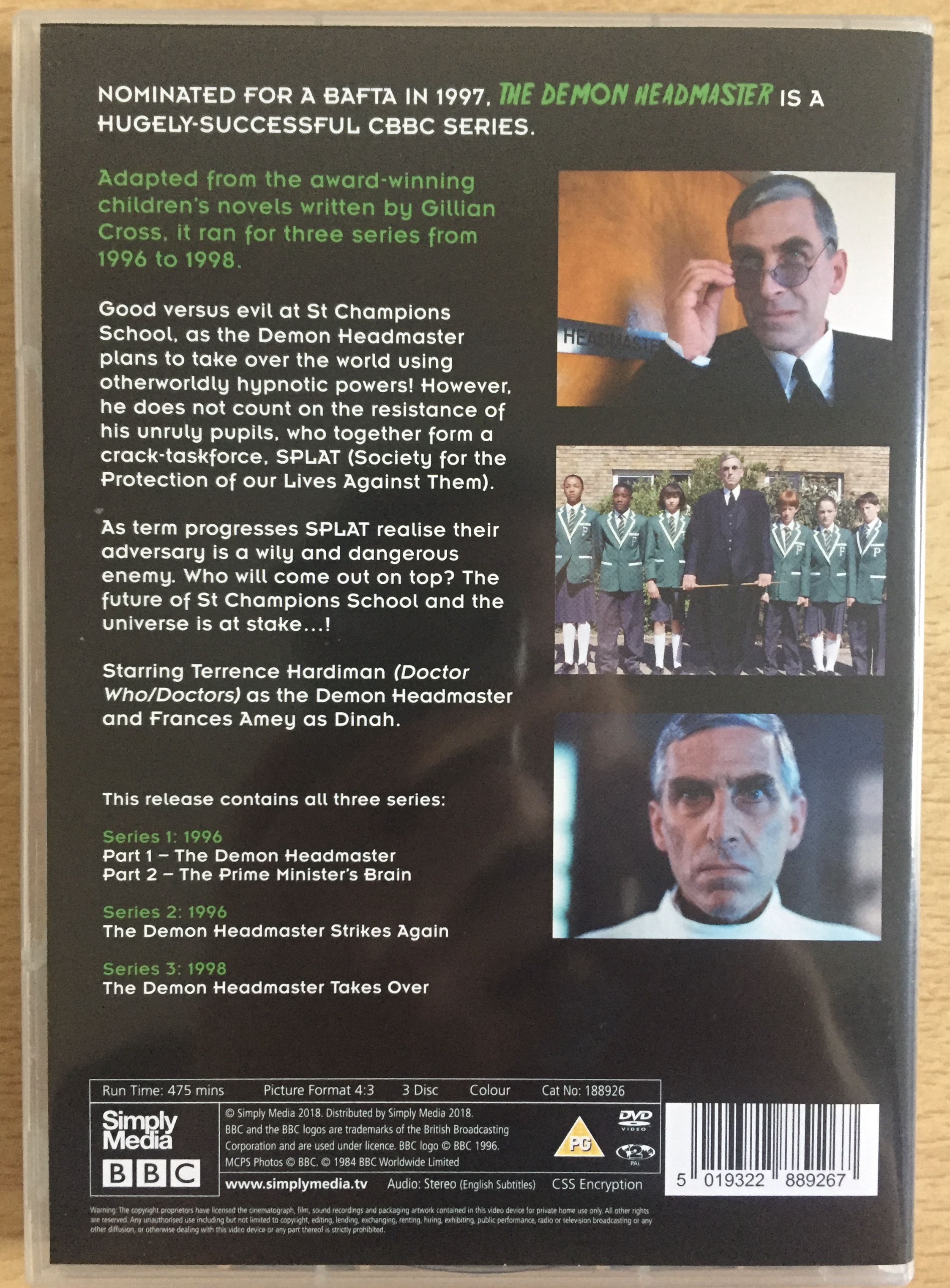 Back cover of the DVD for The Demon Headmaster. Alongside the text are 3 photos from the show featuring the title character, one of him looking over his glasses, one standing in front of a group of his pupils, and one a close-up of him staring straight ahead.