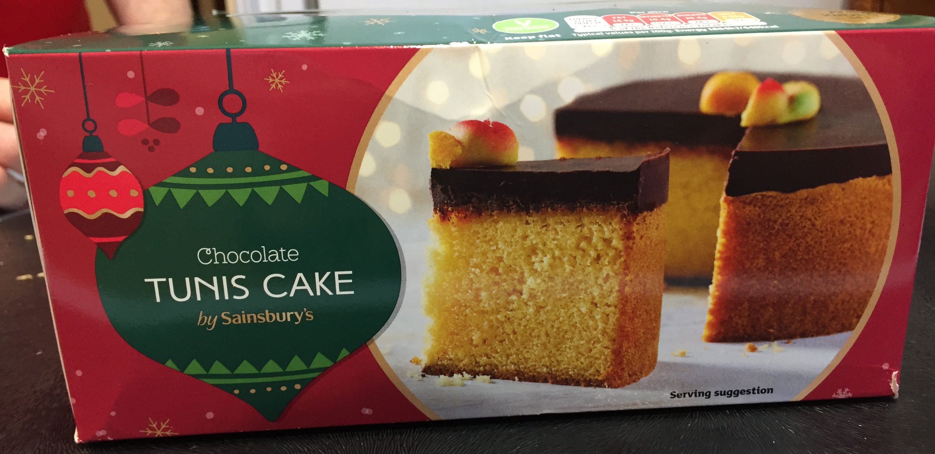 Sainsbury's Tunis Cake, a sponge cake with a thick layer of dark chocolate on the top, with a few marzipan fruits in the centre.