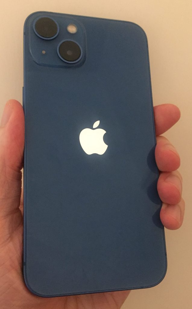 Blue iPhone 13, with an Apple logo in the centre, and 2 cameras positioned diagonally in the top-left corner.