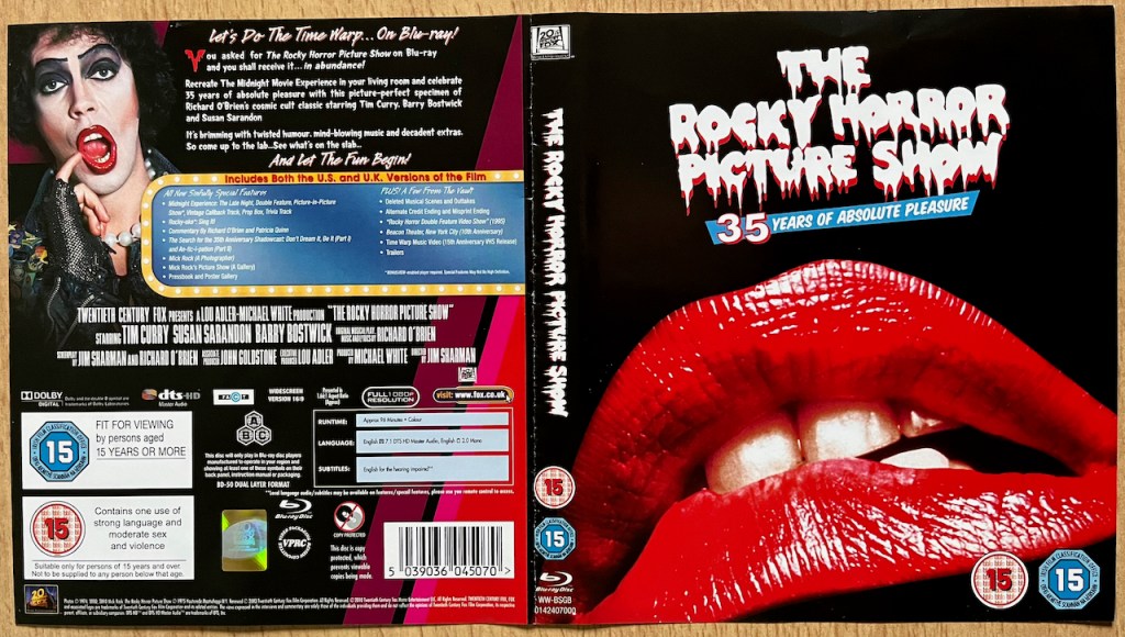 Blu-ray sleeve for the 35th anniversary edition of The Rocky Horror Picture Show. The front cover shows a big pair of glistening red lips, parted slightly to see the teeth in between. The back cover lists the special features, and has a picture of Tim Curry as Doctor Frank N Furter, seductively holding his little finger up to his open lipstick-covered mouth.