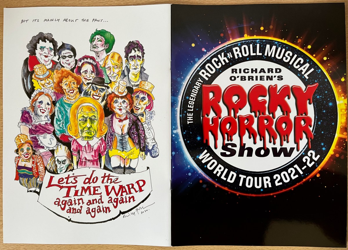 Cover spread of the brochure for the Rocky Horror World Tour 2021-2022. The front cover shows the title, with the words Rocky Horror in red blood-dripping letters. The back cover shows colourful drawings of all the characters, with the text Let's Do The Time Warp Again And Again And Again.