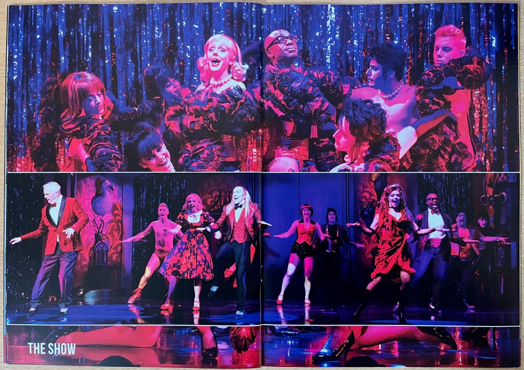 Double-page spread from the Rocky Horror tour brochure, with photos from the show. Across the top of both pages, Brad and Janet join other cast members as they sing and dance in front of a glittering curtain during the cabaret floor show, wrapping red feather boas around themselves, concealing the corsets and lingerie they're wearing. Across the bottom, the Narrator in a red jacket and black trousers joins the other cast members in performing the Time Warp, with everyone taking a step to the right with their arms out to the sides.