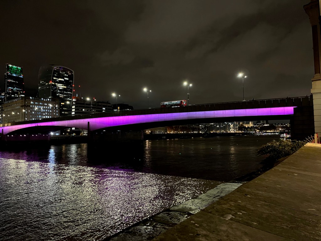 London Bridge, with purple light spanning its 2 wide arches.