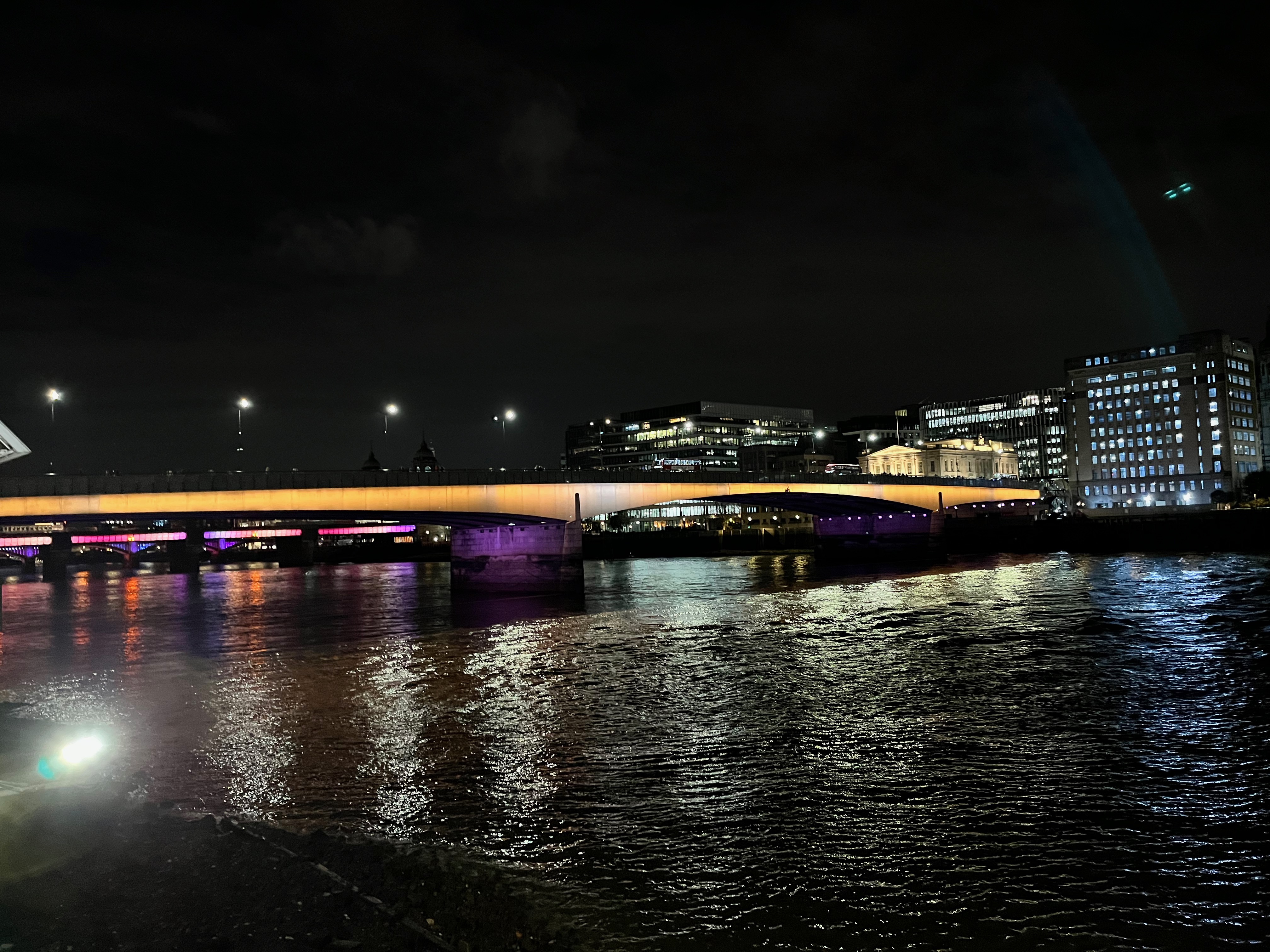 London Bridge, with yellow light spanning its 2 wide arches.