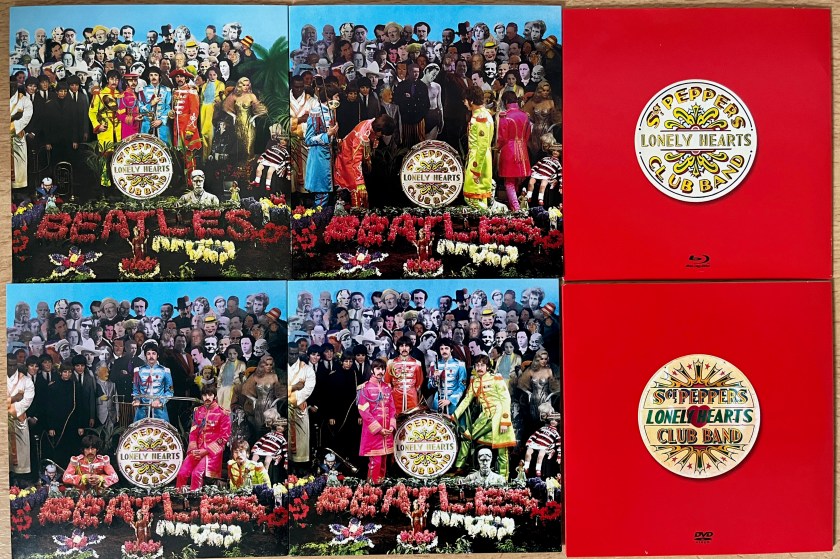 Front covers of the disc sleeves from the Sergeant Pepper box set. The 4 CD sleeves each have a variation of the main album cover, with the band members in their colourful military-style tunics posing in a different way in each case, in front of the collage of people behind them. The DVD and Blu-ray sleeves have the round logo for Sergeant Pepper's Lonely Hearts Club Band against a red background.