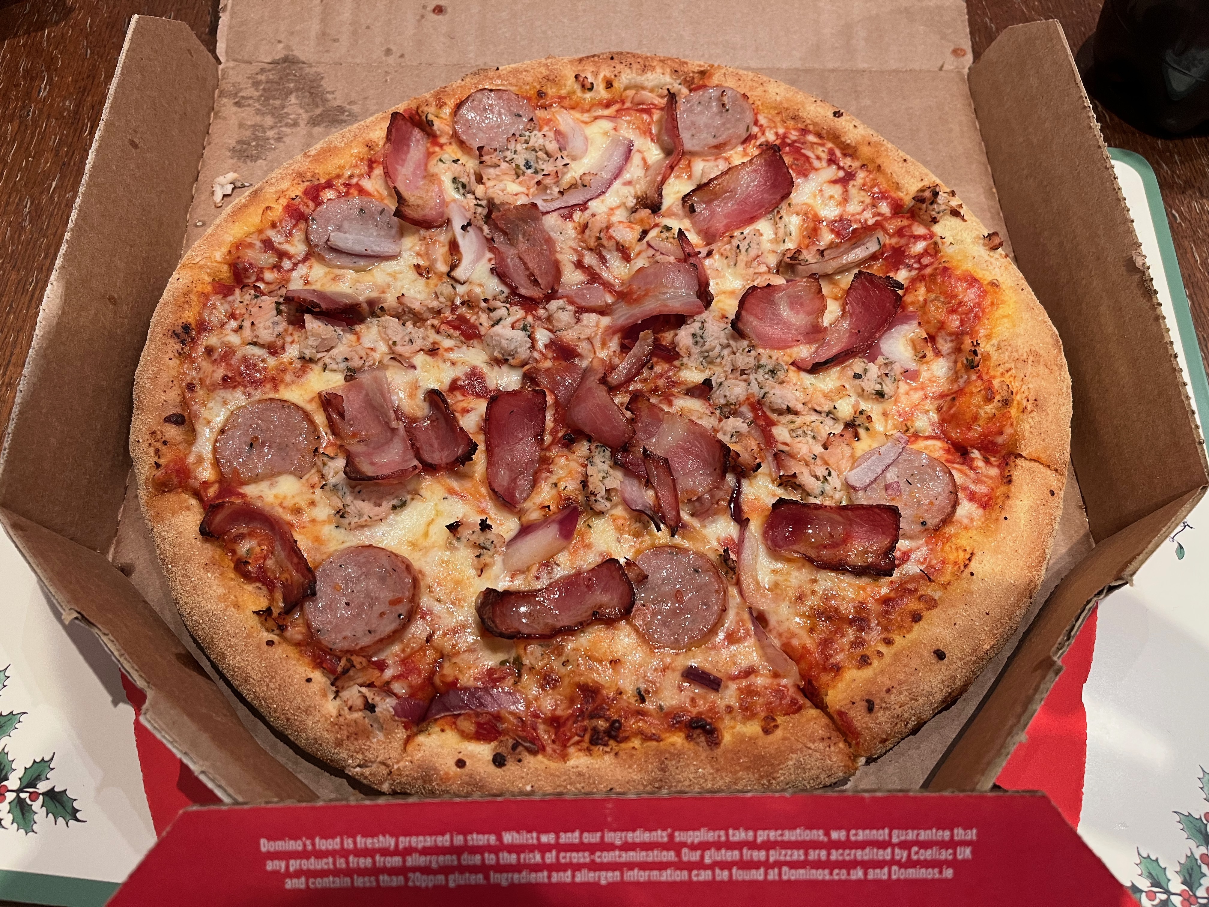 Festive pizza from Domino's, topped with sage & onion turkey, sausage, smoked bacon, onions and mozzarella cheese.