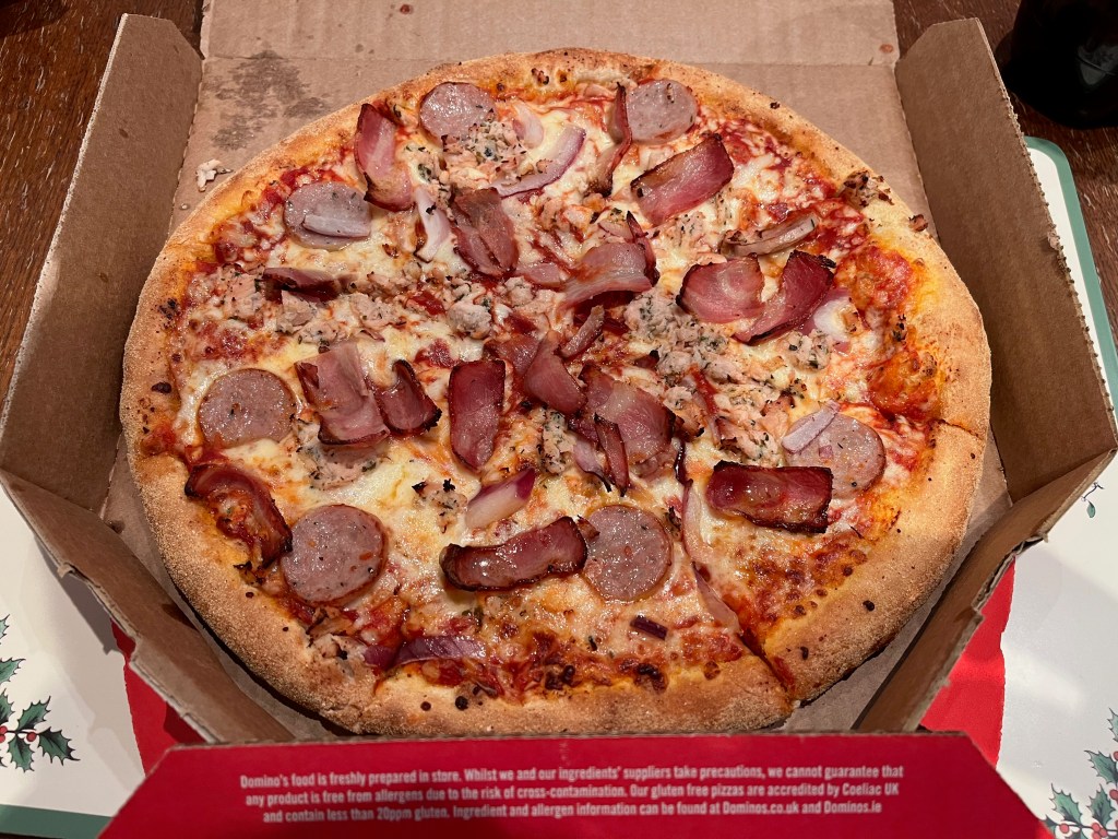 Festive pizza from Domino's, topped with sage & onion turkey, sausage, smoked bacon, onions and mozzarella cheese.