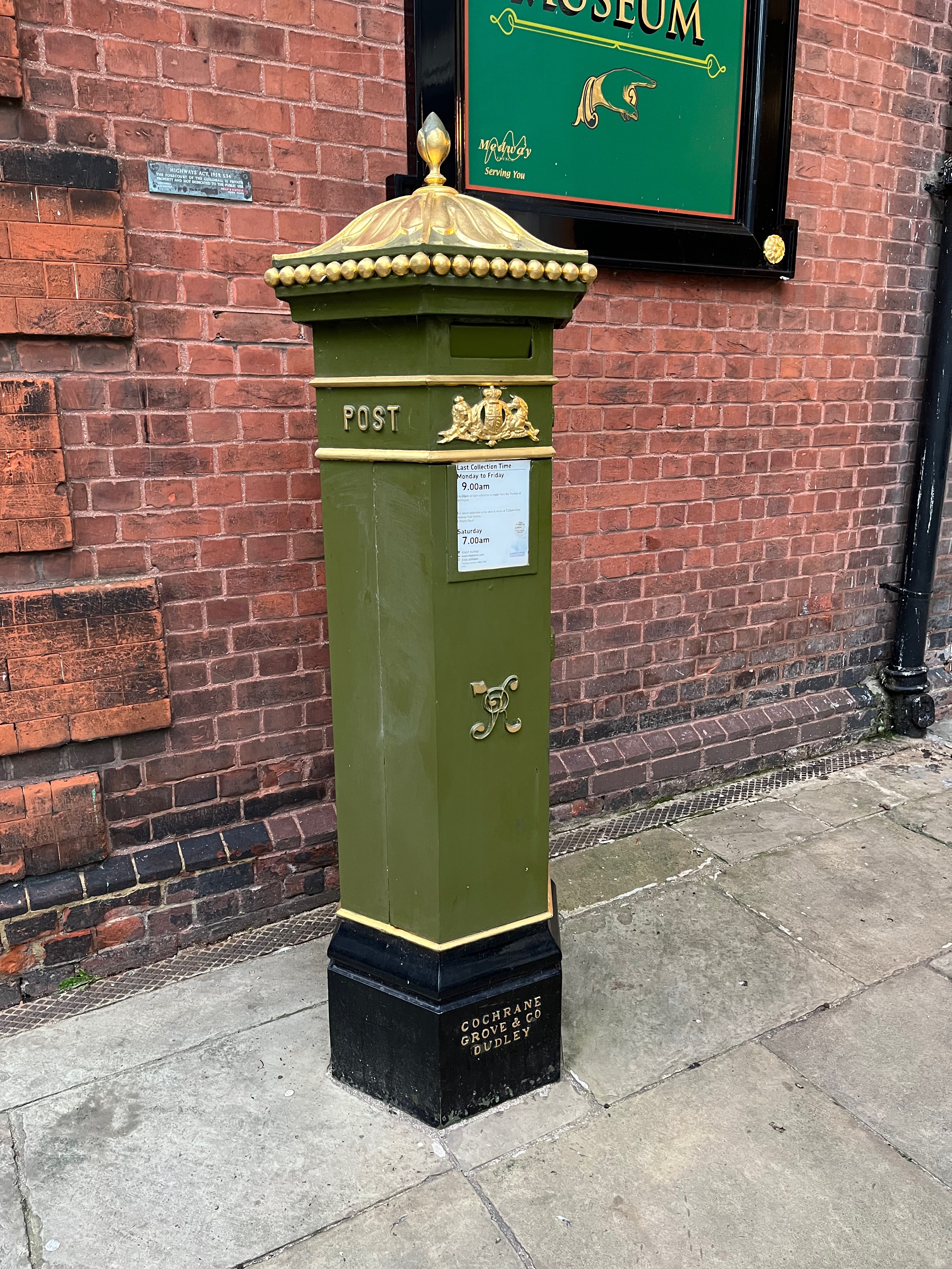 Tall Victorian pillar box painted in green.