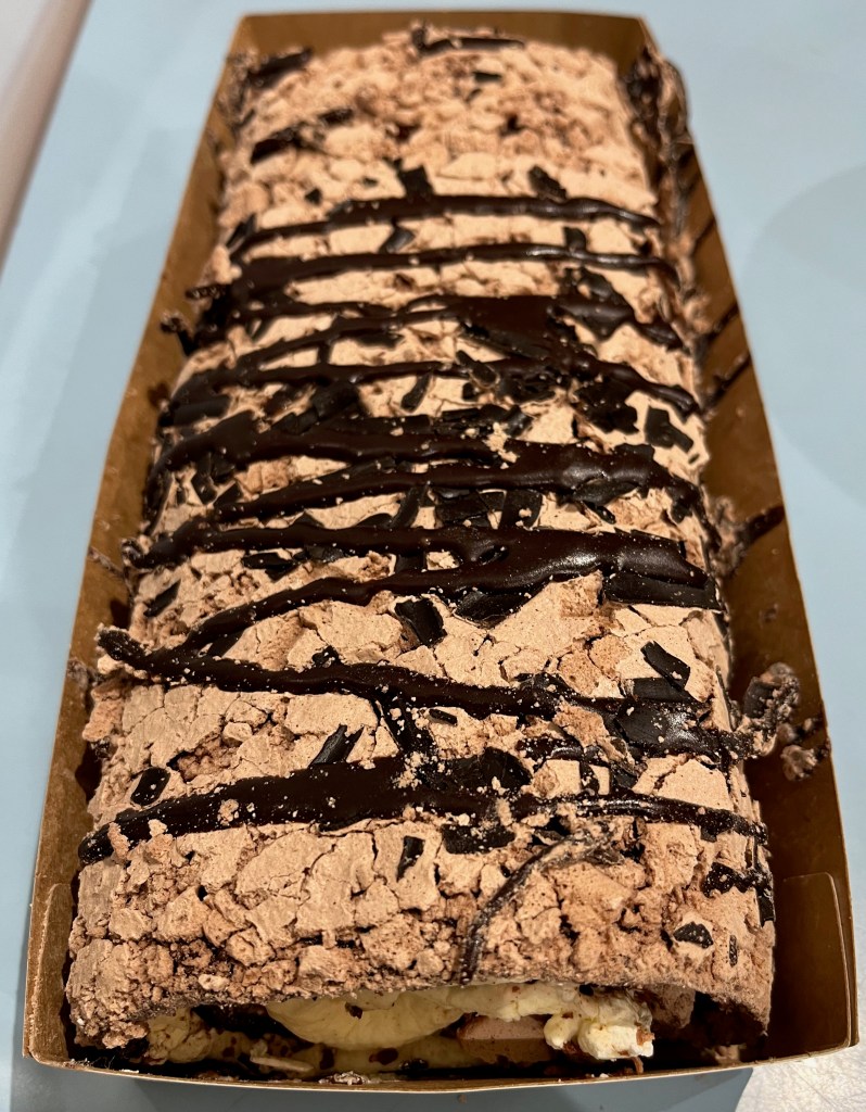 Sainsbury's Belgian Chocolate Roulade, a long chocolate meringue dessert with whipped cream inside and layers of Belgian chocolate on top.