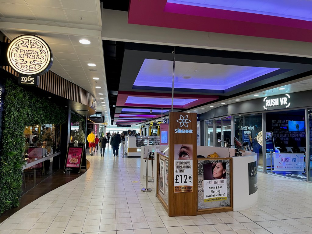 A section of corridor in the Xscape centre, including Pizza Express and Rush VR.
