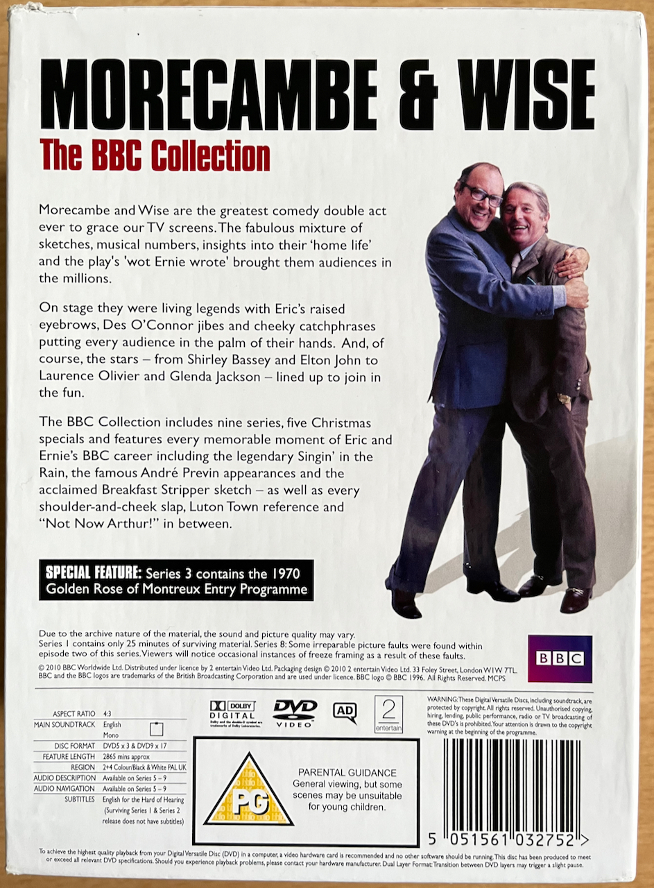 Back cover for the DVD box set of Morecambe And Wise - The Complete BBC Collection, showing a photo of Eric hugging Ernie, next to text about the contents of the set.