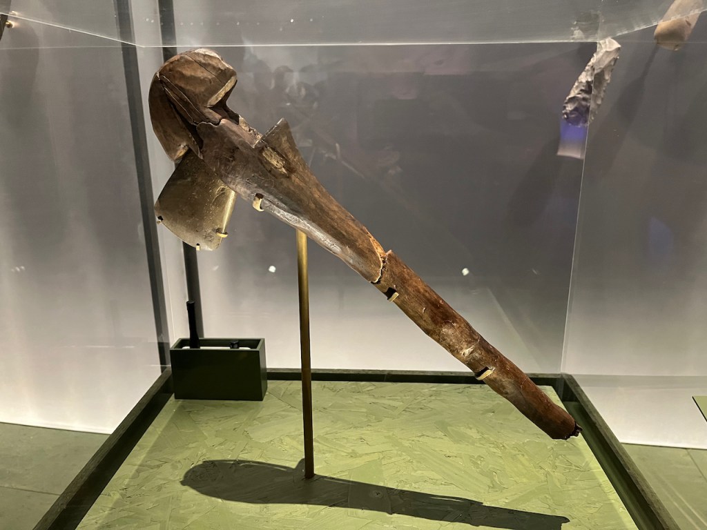 A large, old wooden axe.