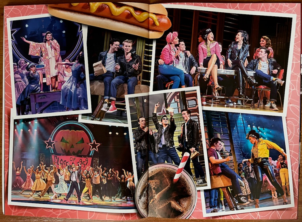 2-page spread from the programme for Grease The Musical, with a collage of images from different scenes in the show. One shows the whole cast standing with legs apart and hands in the air, in front of a backdrop that has an image of a carved Halloween pumpkin and a banner reading Class of 1959. Other photos show the boys and girls hanging out and singing or talking with their respective gang members.