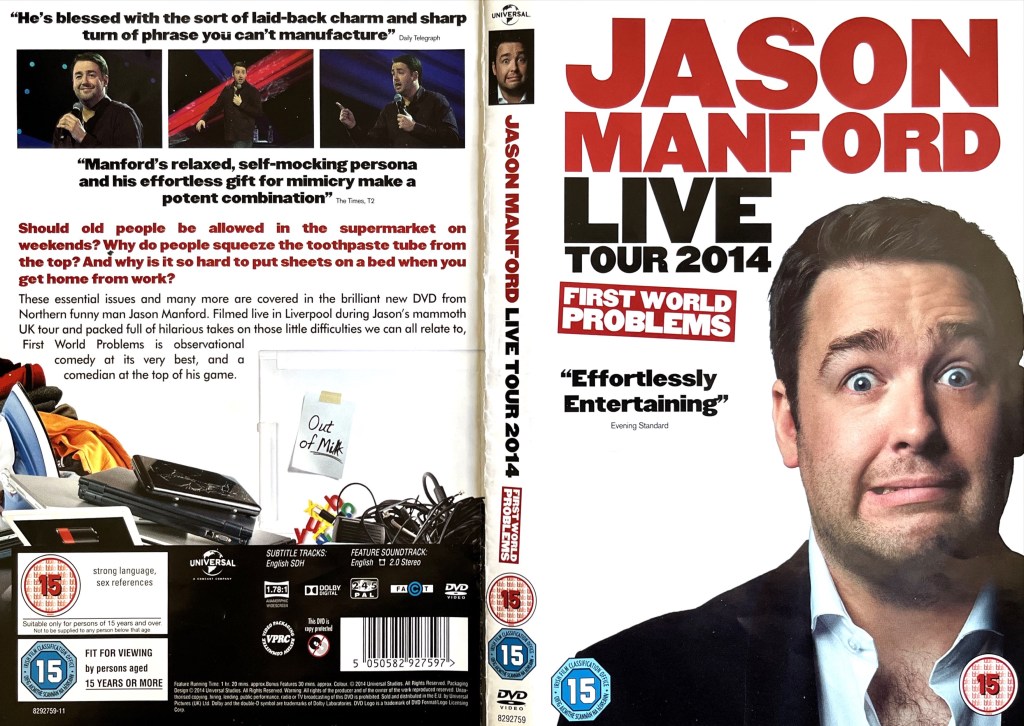 DVD cover spread for Jason Manford - First World Problems. The front of the sleeve shows Jason pulling a scared face with his eyebrows raised and eyes wide open. The back cover shows a few images of Jason performing above the description of the DVD, while at the bottom there are a few examples of the first world problems described in the title, including a pile ironing, a smartphone with a badly cracked screen, a bunch of tangled electrical cables, and a note stuck to a fridge saying out of milk.