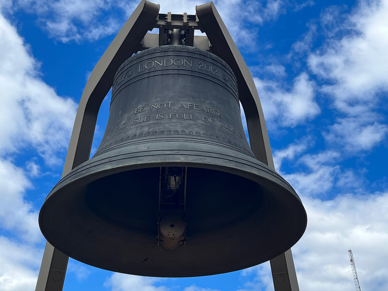 The large Olympic bell, on display in the Olympic Park. Text engraved on the bell reads London 2012, Be Not Afeared, The Isle Is Full Of Noises.
