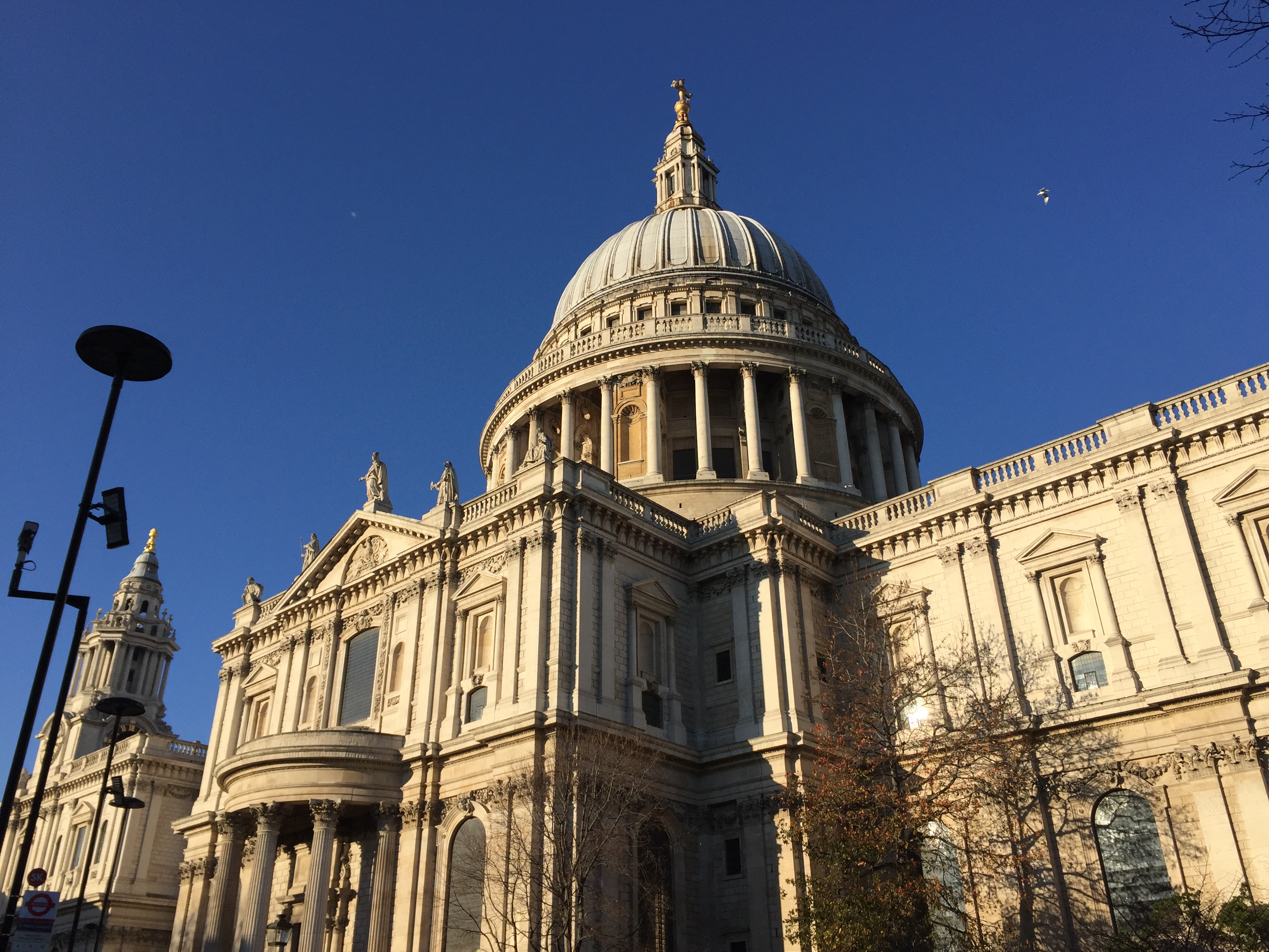 Side view of St Paul's Cathedral in the sunshine, with the big domed roof clearly visible.