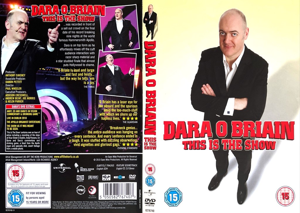 DVD cover spread for Dara O Briain - This Is The Show, featuring Dara standing in a suit with his arms crossed on the front cover, and photos from the show alongside the description of the DVD on the back cover.