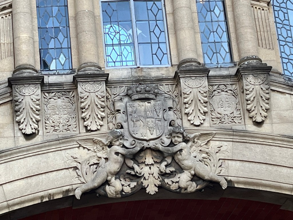 Close-up of the coat of arms and ornate patterns sculpted into the centre of the Hertford College bridge.