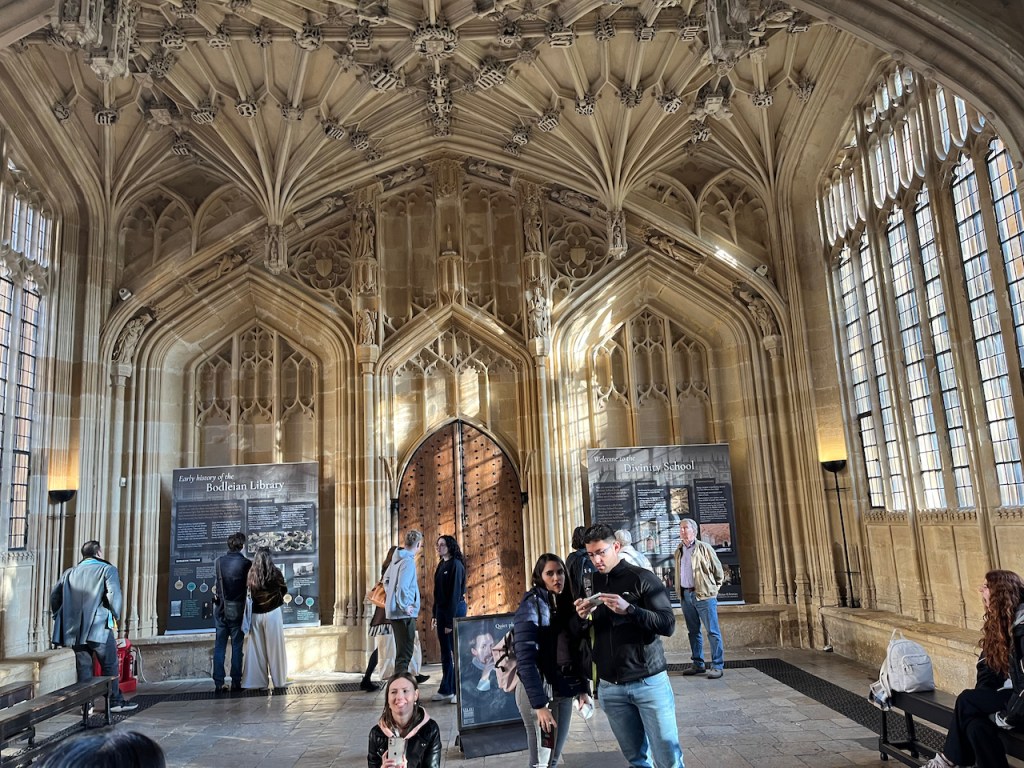 The interior of the Divinity School, with very detailed architecture on the walls and ceiling.