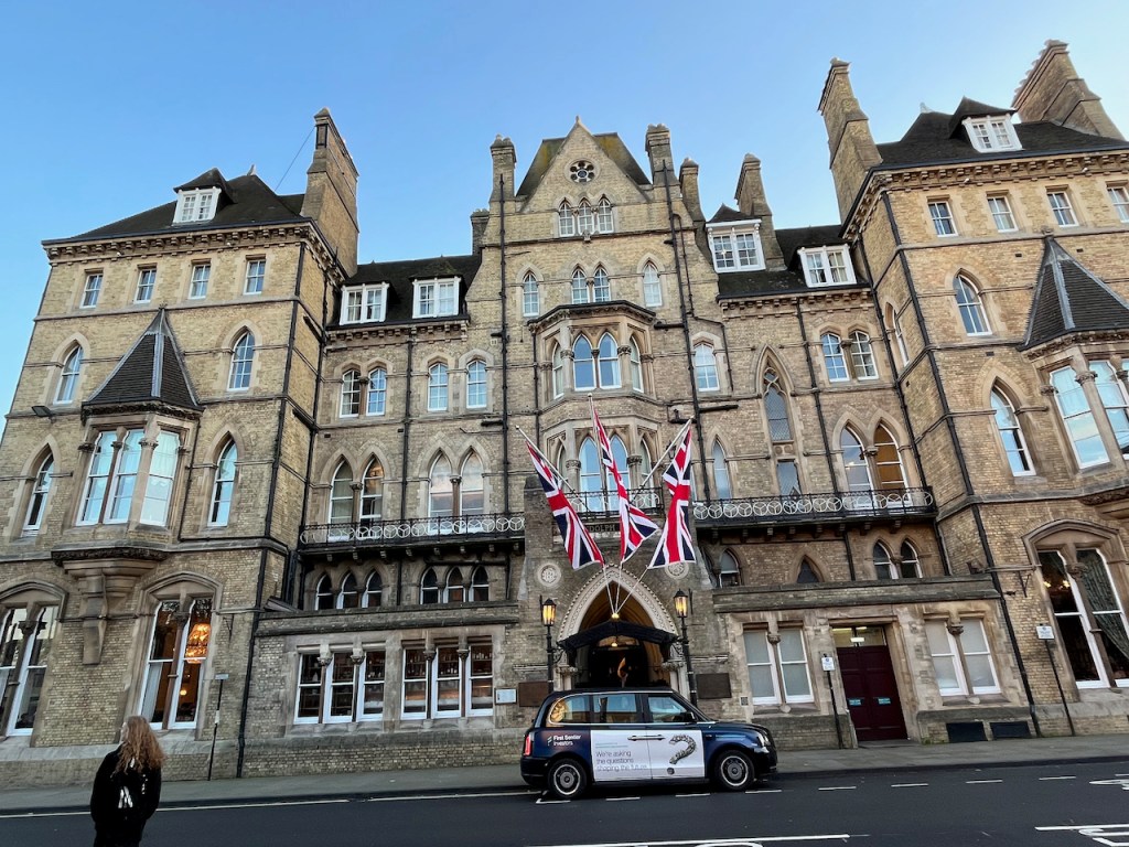 The Randolph Hotel, a large 4-storey building with 3 Union Jack flags hanging over the entrance.