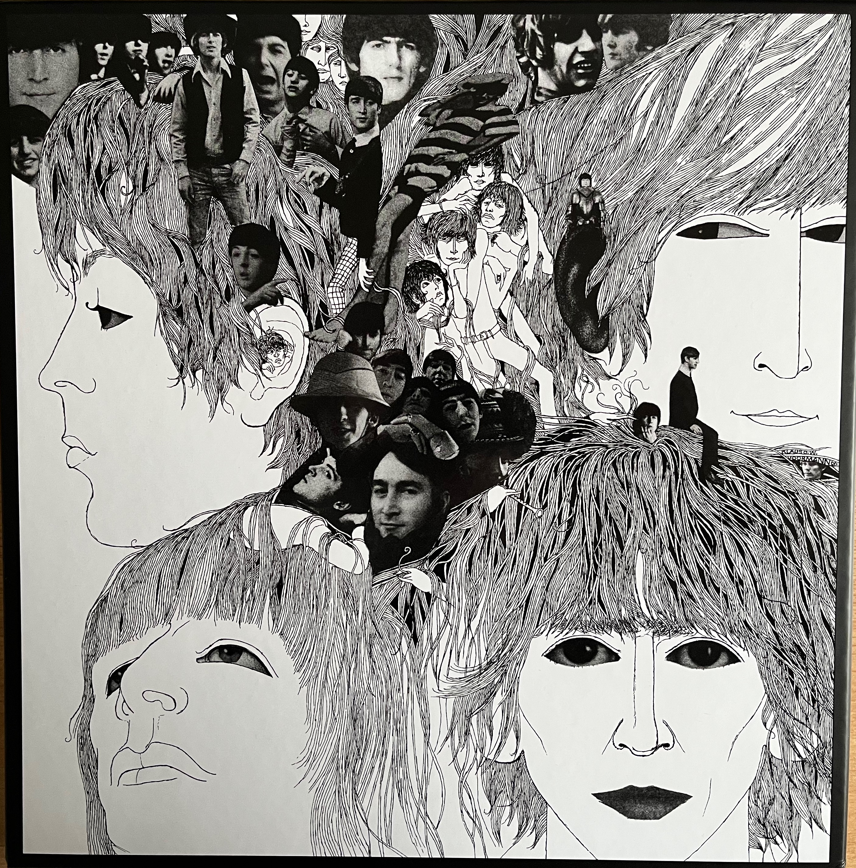 Front cover of the super deluxe box set for the album Revolver by The Beatles. It shows large black and white sketch-style headshots of the 4 band members, with smaller black and white photos of the band members in the spaces between them.