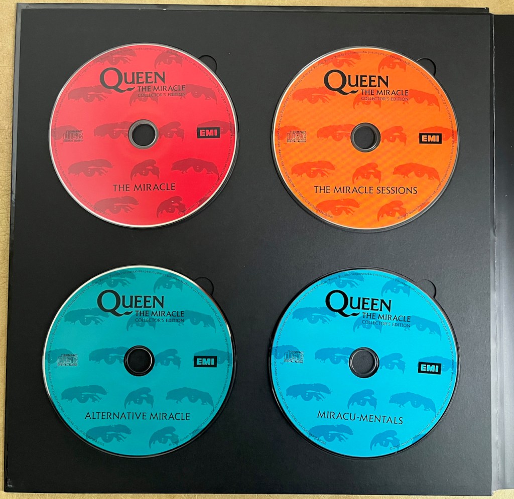 The 4 music CDs from Queen's box set for The Miracle, which are coloured red for the main album, orange for the sessions, turquoise for the alternative tracks and light blue for the instrumentals.