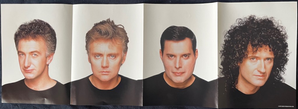A wide poster split into 4 panels, each featuring a headshot of a member of Queen, namely John, Roger, Freddie & Brian from left to right. Each is wearing a black round neck top and is in front of a white background, and their shoulders join together across the panels.