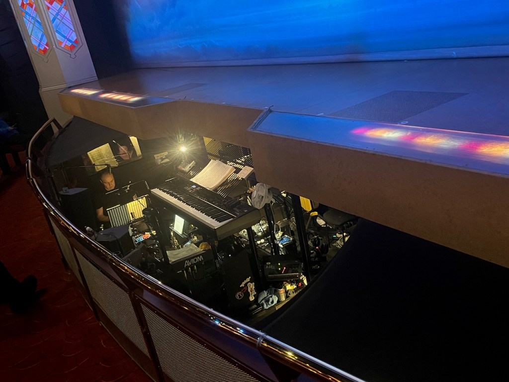 The orchestra pit in front of the stage for The Book Of Mormon, including a large keyboard.