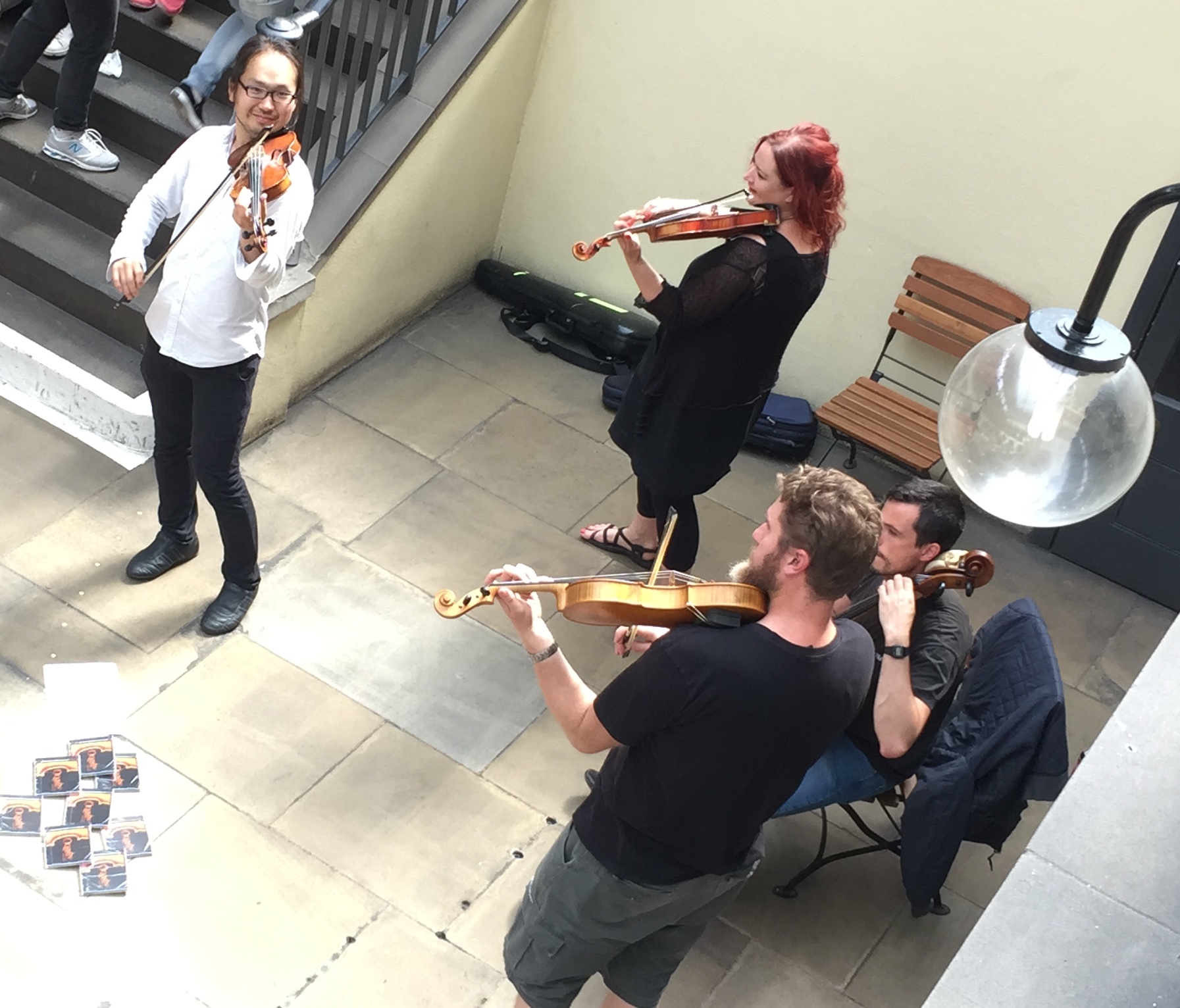 A quartet of violinists playing in the dining area in Covent Garden.