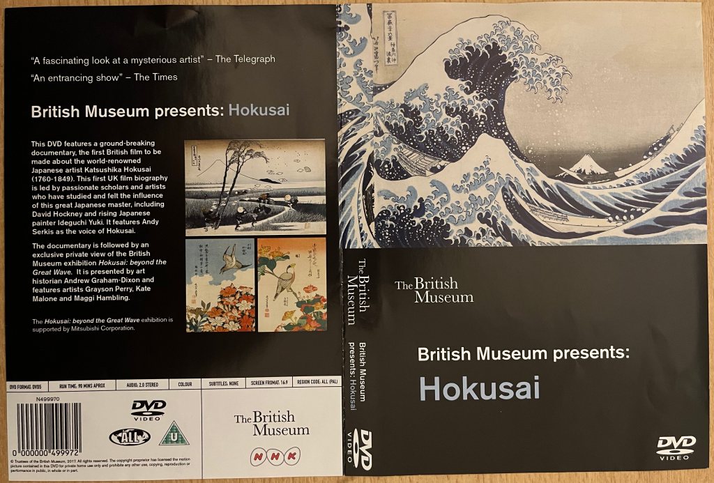DVD cover spread for the Hokusai documentary by The British Museum. The front cover shows his painting The Great Wave, with boats being dwarfed by huge waves in a stormy sea. The back cover has a few small images of more of his paintings alongside a description of the documentary.
