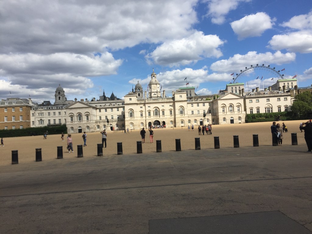 Horse Guards Parade, a large open space for parades with large stone buildings all along the back.