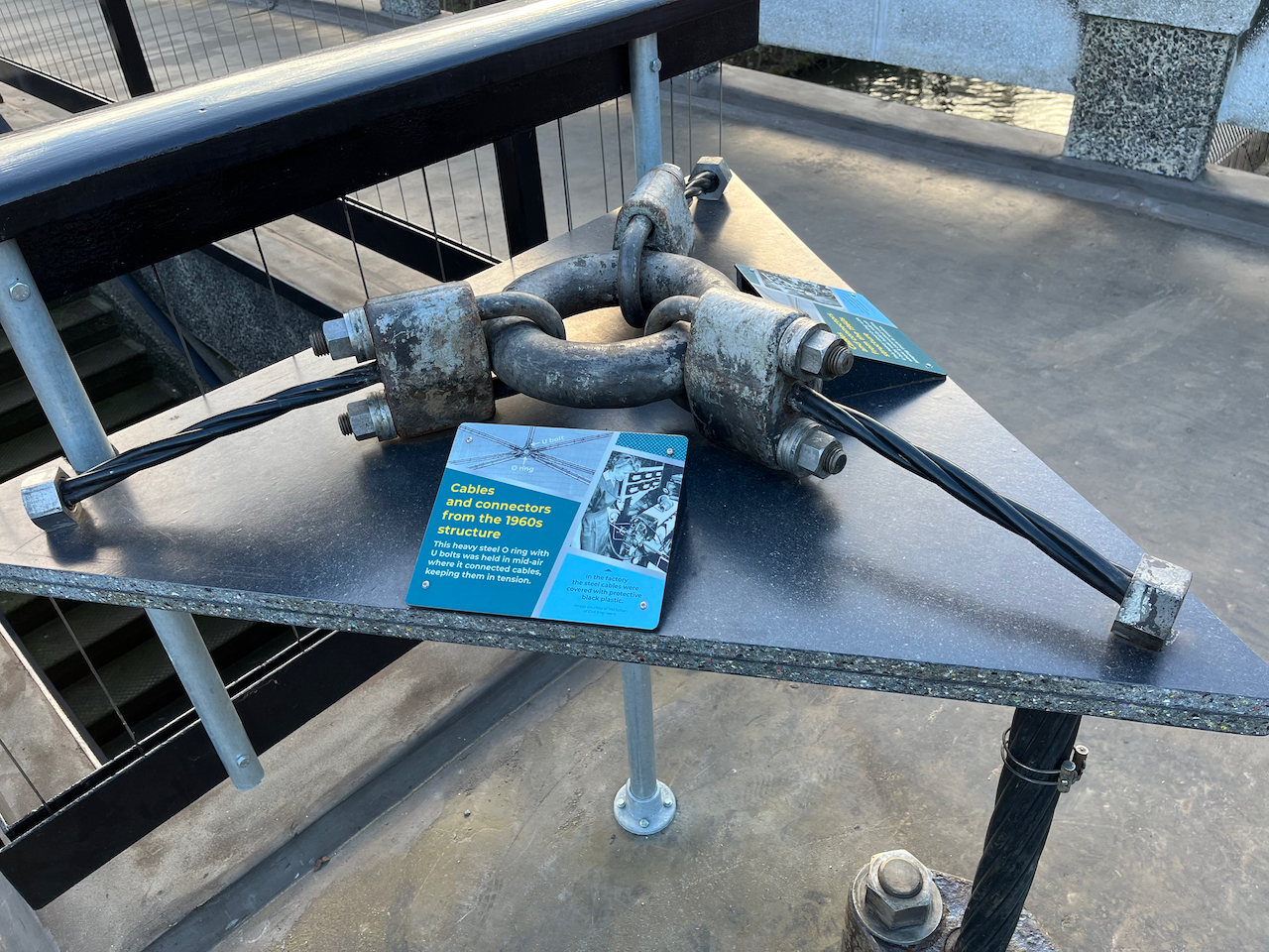 A very large, heavy duty, steel ring, used as part of the original Snowden Aviary structure at London Zoo, laid on a table so that visitors can feel it.