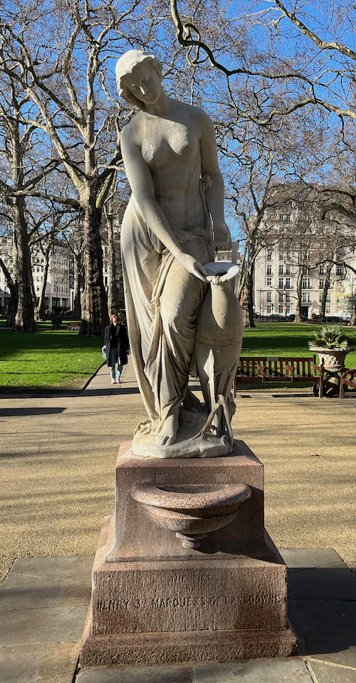 Statue of the Woman of Samaria, also called the Water Carrier. It depicts the graceful female figure of a nymph holding an overflowing urn, with one hand resting on the rim of the urn, the other grasping its handle.
