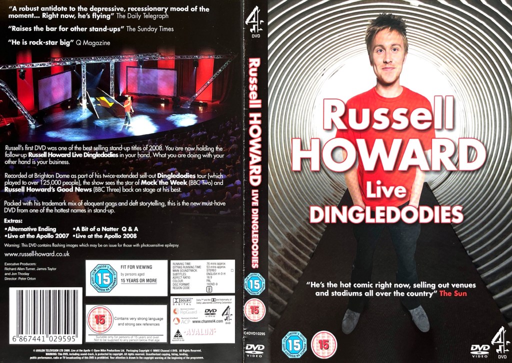 DVD cover spread for Russell Howard Dingledodies. The front cover shows Russell smiling in a red t-shirt and black trousers, standing in front of a swirling white background, while the back cover shows a view of Russell on stage, taken from a high vantage point in the theatre, above the description of the DVD.