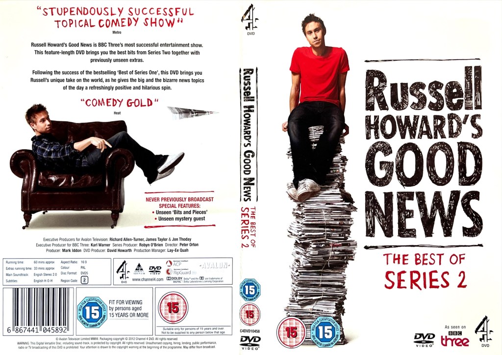 DVD cover spread for Russell Howard's Good News - The Best Of Series 2. The front cover shows Russell, in a red t-shirt, black trousers and white trainers, sitting on top of a very tall pile of newspapers. The back cover shows him lazing on a leather chair, positioned sideways so that his back rests against one arm of the chair while his legs rest over the other arm in front of him.