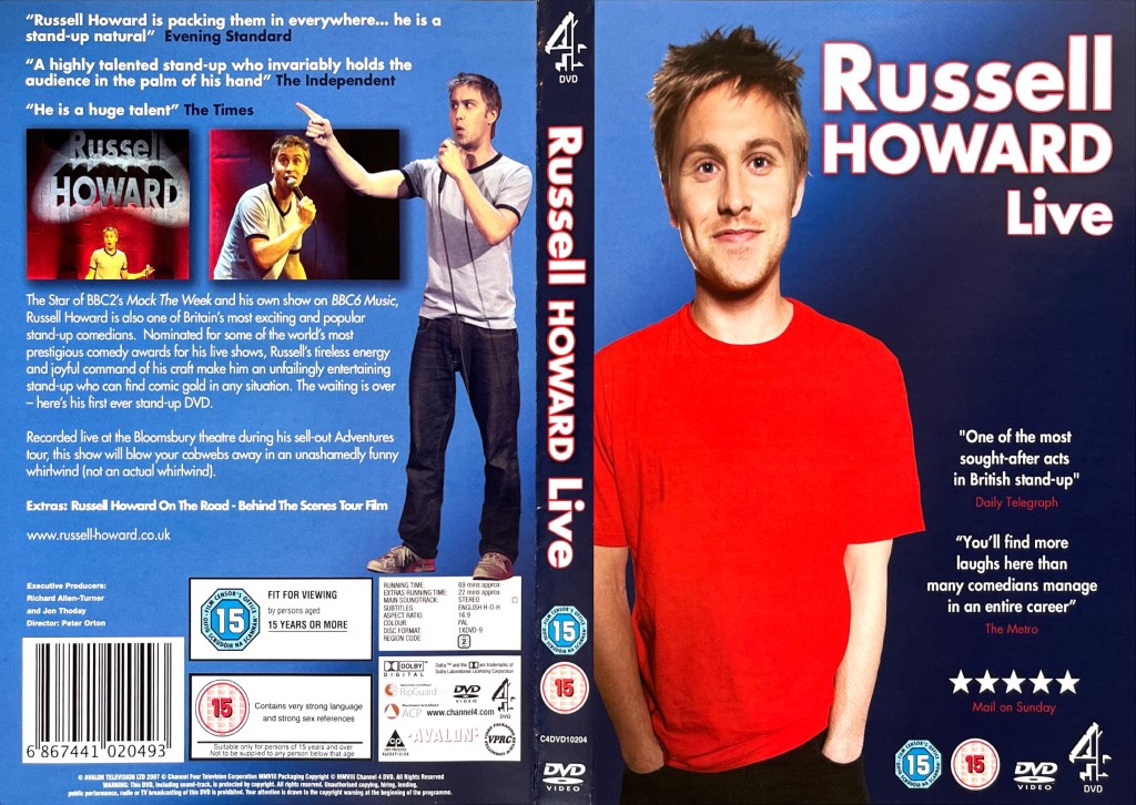 DVD cover spread for Russell Howard Live. The front cover shows Russell smiling in a red t-shirt. The back cover shows him talking with a microphone while wearing a grey t-shirt and dark navy jeans, alongside a couple of smaller images from the show and a description of the DVD.