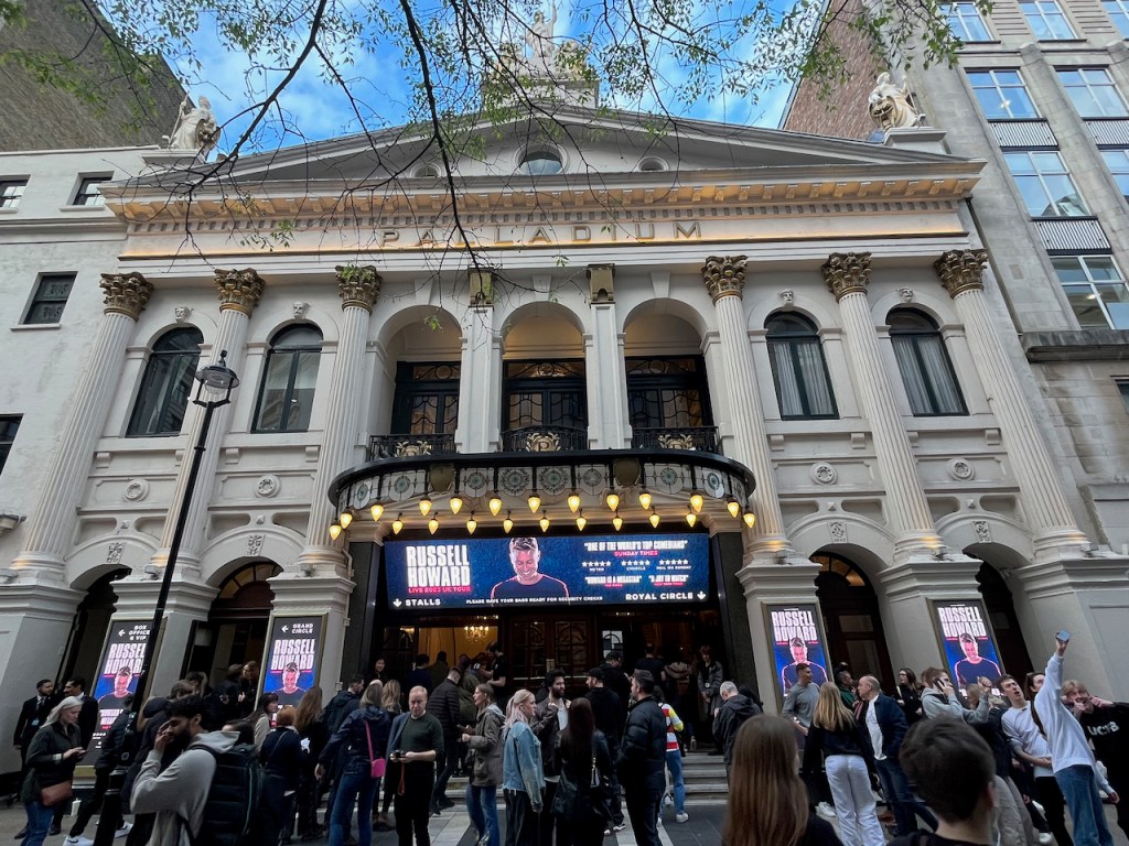 The London Palladium in daylight, as a large crowd of people enter for Russell Howard's show.