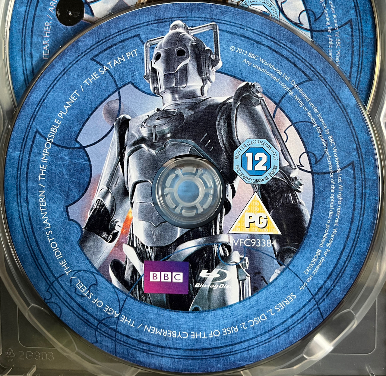 Disc 2 in the Doctor Who Series 2 Blu-ray set, featuring a photo of a Cyberman. A blue border around the edge of the disc contains the episode names and copyright information.
