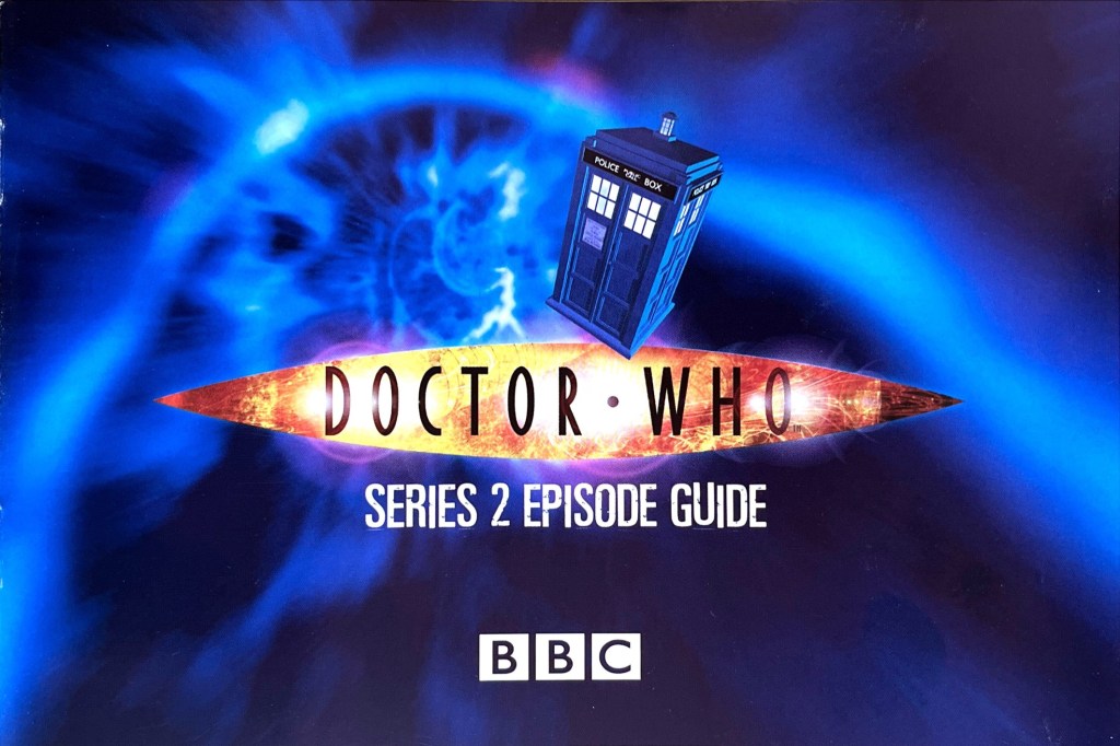 Title page from the Doctor Who Series 2 Episode Guide booklet included with the original DVD release. The Doctor Who logo, episode guide title and BBC logo are shown in front of the blue time vortex, which the Tardis is flying through, just passing over the Doctor Who logo as it does so.