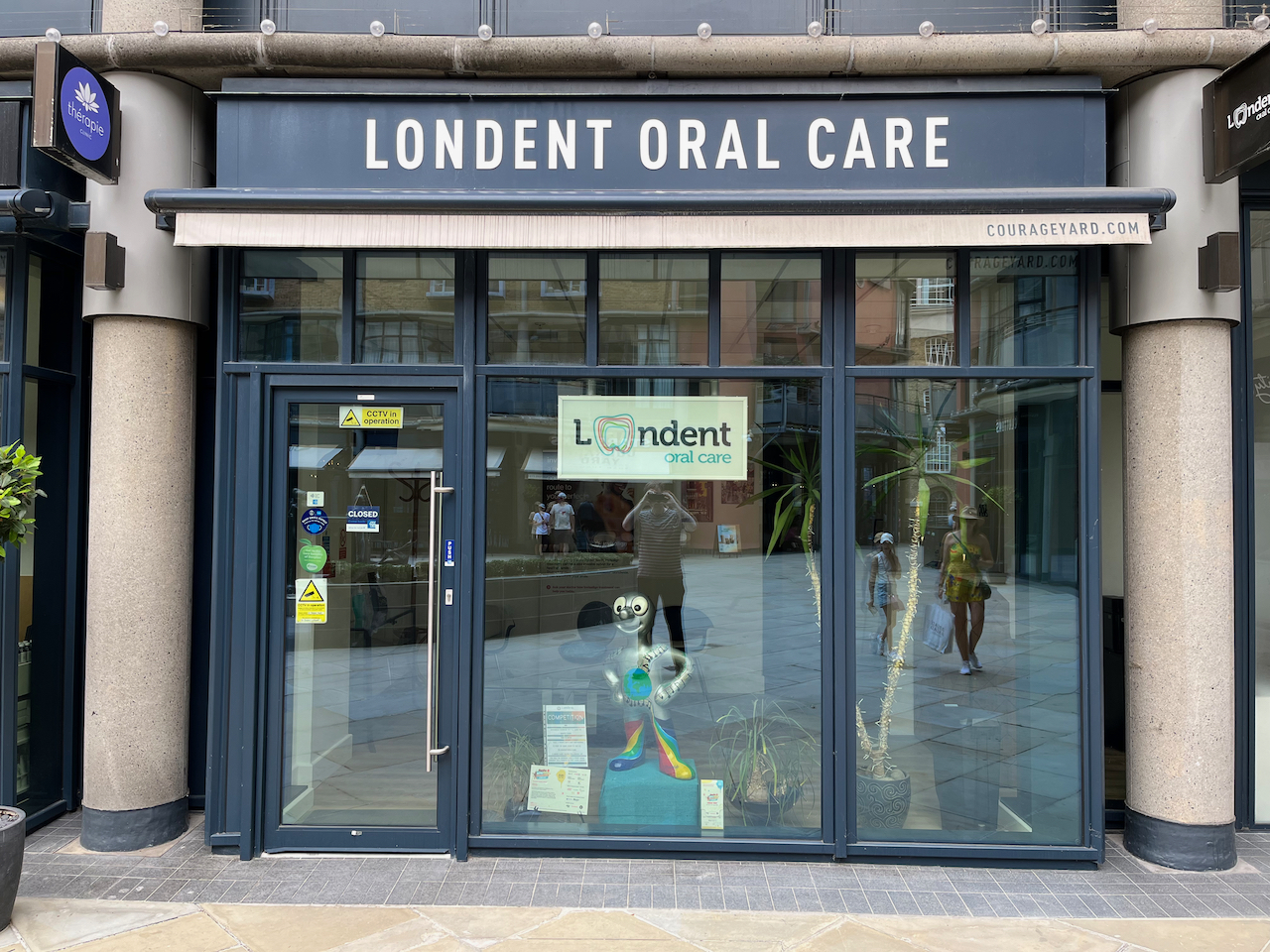 The exterior of Londent Oral Care, with a small Morph statue visible in the central window.