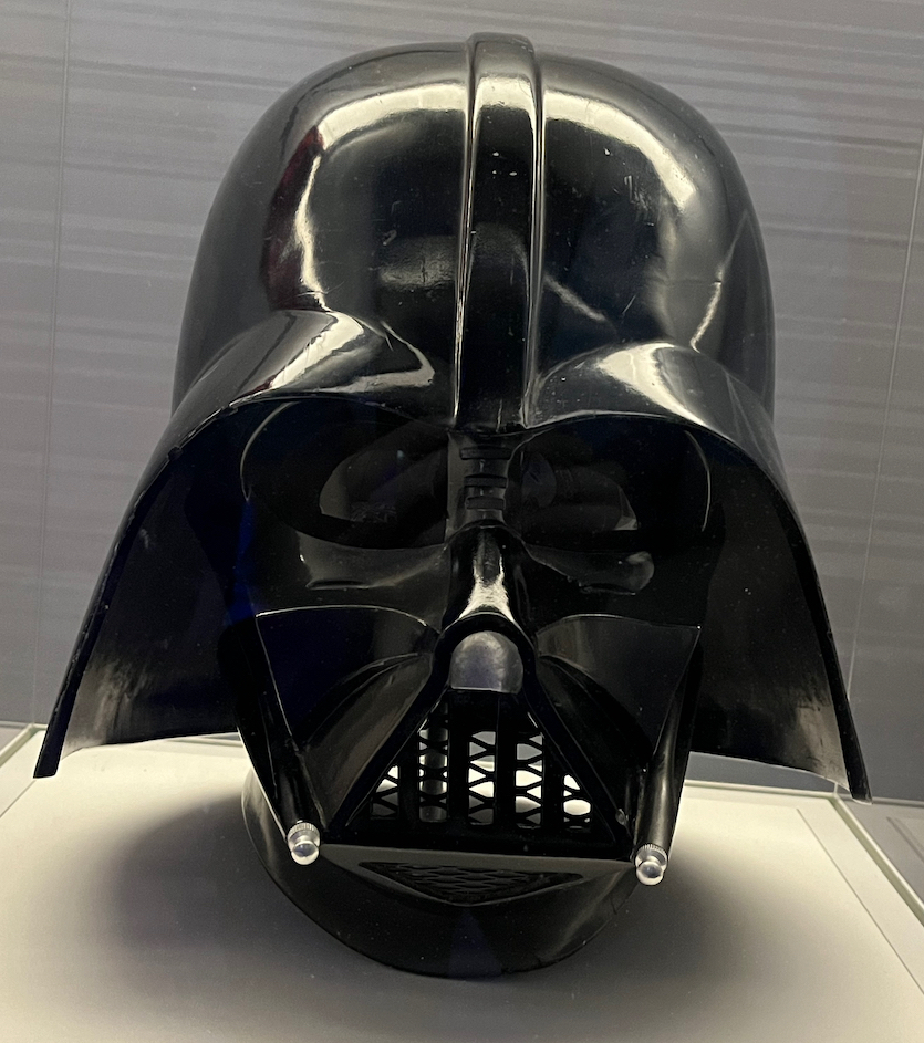 Darth Vader's black helmet from Star Wars, which covers his entire face with a mouth grille to breathe through.