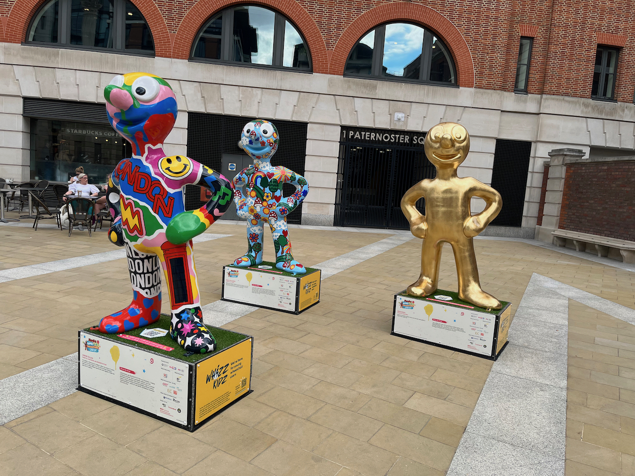 3 colourful statues of Morph outside 1 Paternoster Square.