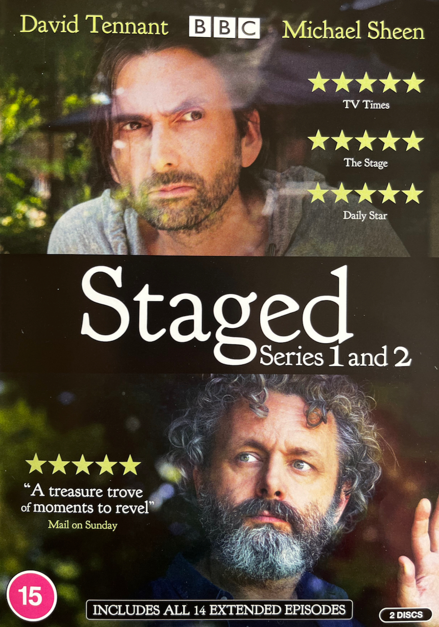 Front cover of the DVD set for Series 1 and 2 of Staged, featuring photos of David Tennant and Michael Sheen, one above the other. The cover also shows that the show had 5 star reviews by the TV Times, The Stage, The Daily Star and The Mail On Sunday, with a quote from the latter reading a treasure trove of moments to revel.