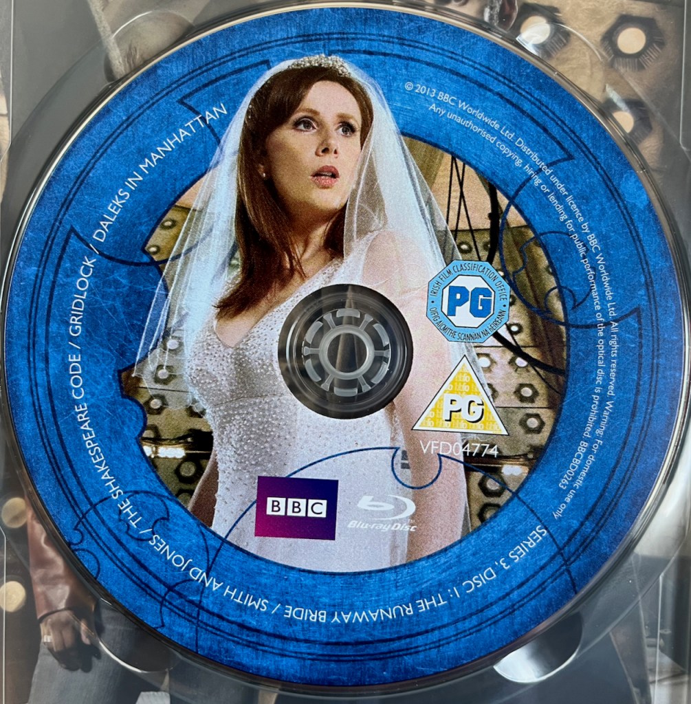 Disc 1 in the Doctor Who Series 3 Blu-ray set, featuring a photo of Donna Noble wearing a white wedding dress and veil. A blue border around the edge of the disc contains the episode names and copyright information.