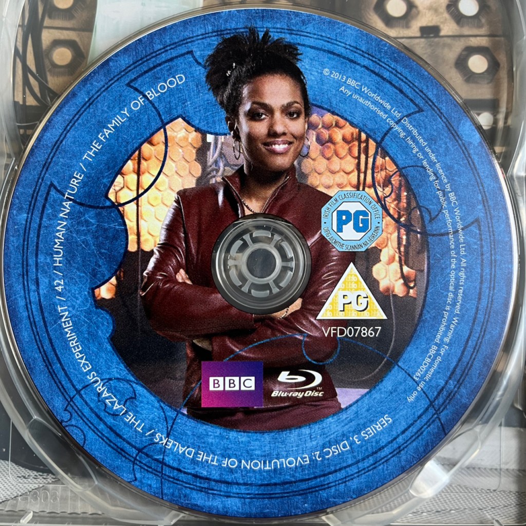 Disc 2 in the Doctor Who Series 3 Blu-ray set, featuring a photo of Martha Jones wearing a red leather jacket. A blue border around the edge of the disc contains the episode names and copyright information.