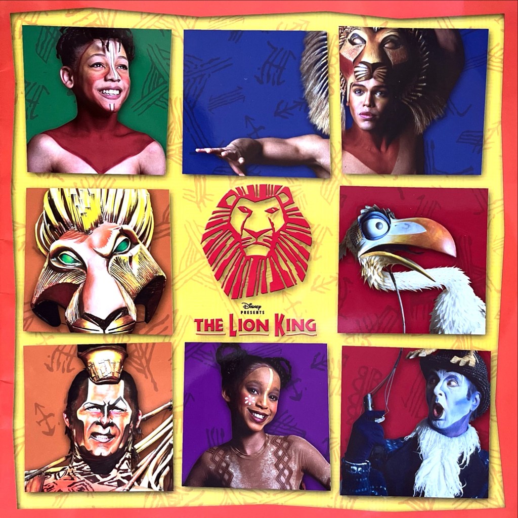 The cover of the children's programme for the Lion King musical, consisting of a grid of 9 squares with characters from the production surrounding the lion face logo in the centre.